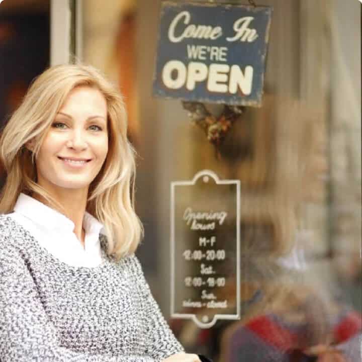 Woman in front of an open sign