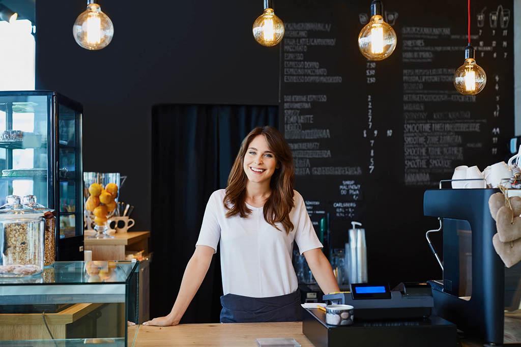 Woman smiling behind a counter