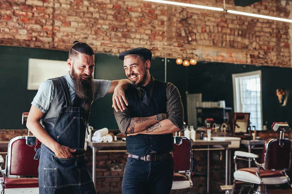 Two guys laughing in a barber shop