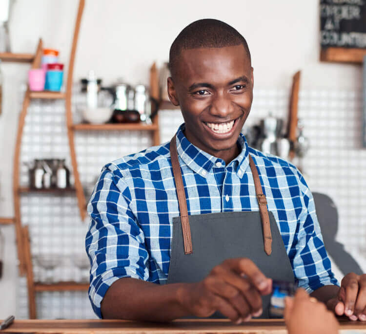 Man smiling behind a counter